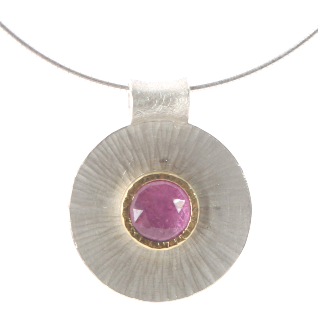 Chequerboard ruby set in gold on small rays disk as pendant on silver