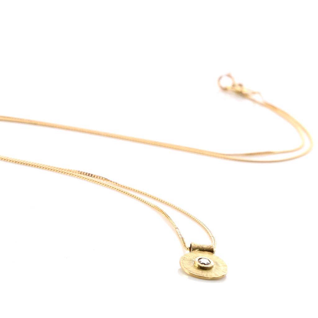 Rosecut diamond in yellow gold setting on rays gold disk was pendant on gold chain