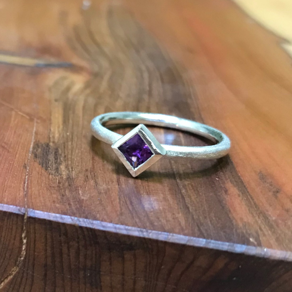 Square purple amethyst in silver on silver band