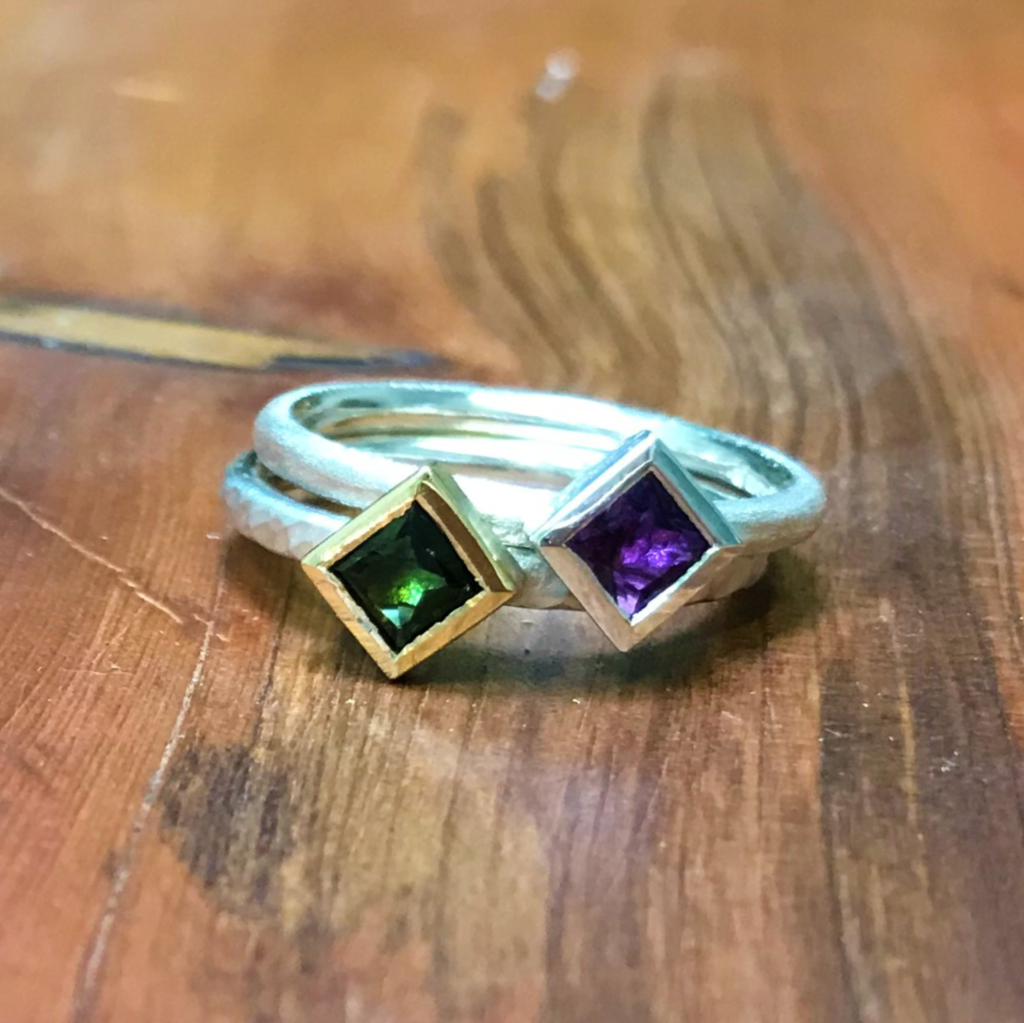 Stacked rings or green tourmaline and purple amethyst