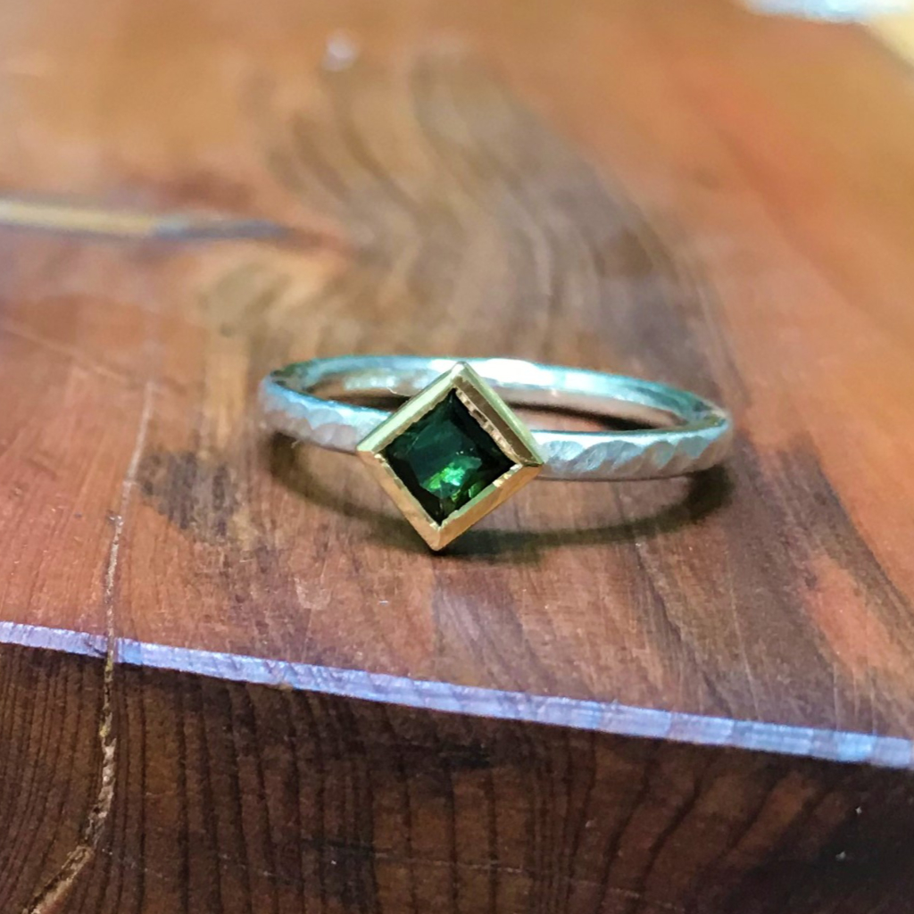 Square green tourmaline in gold on silver band