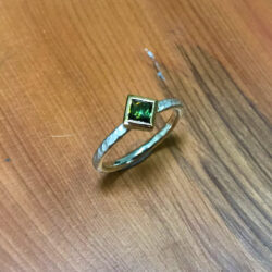 Square green tourmaline in gold on silver band