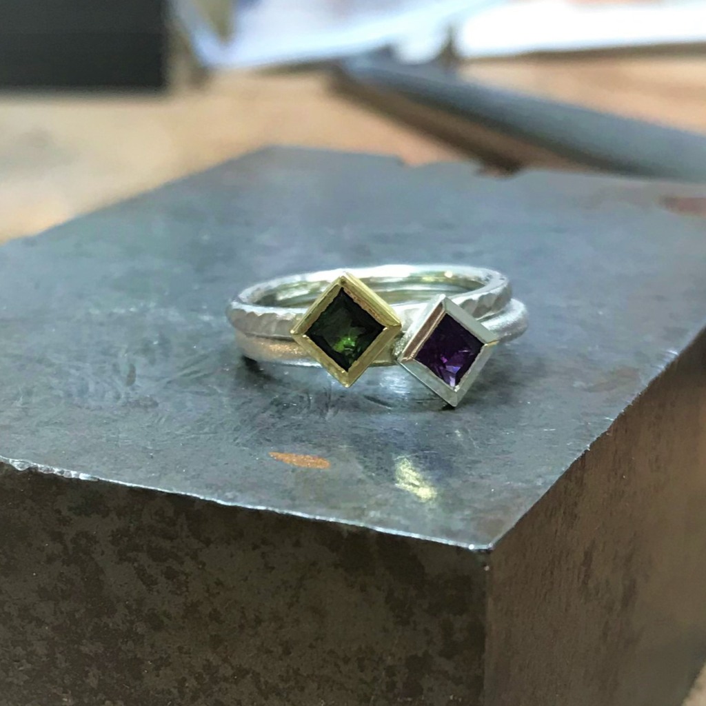 Stacking of green tourmaline and purple amethyst rings