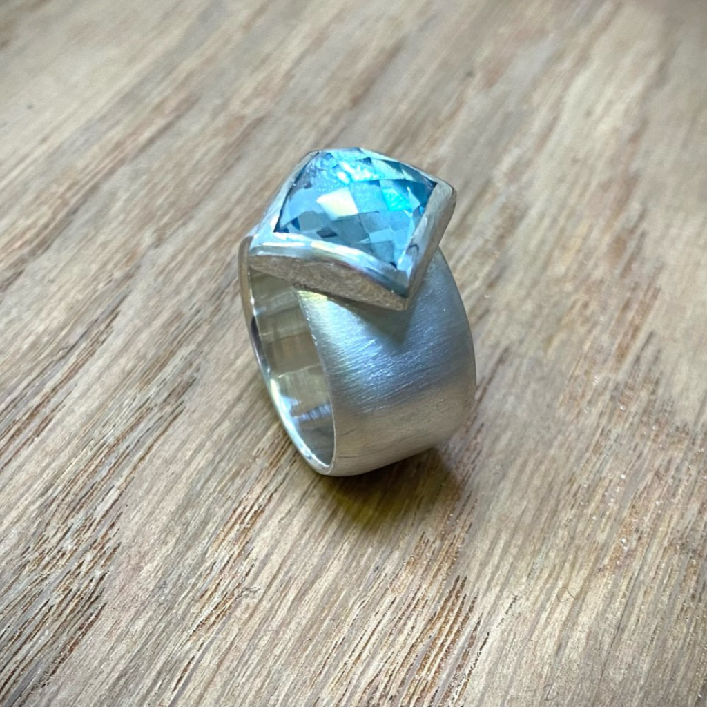square blue topaz offset silver setting on silver ring