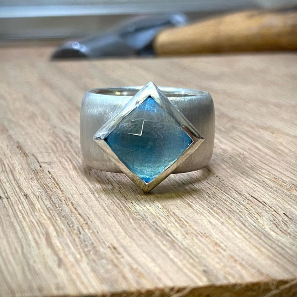 square blue topaz offset silver setting on silver ring