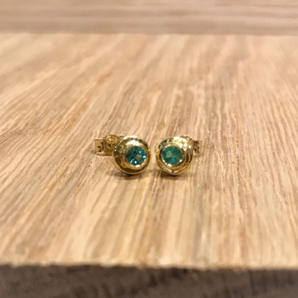Emerald studs in gold