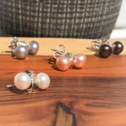white button pearl stud in silver, other colours behind