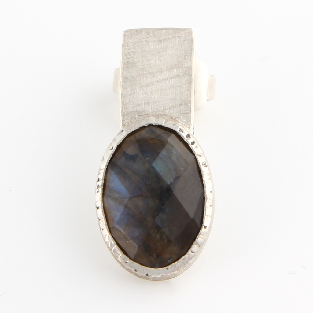 Earring of labradorite cabochon in silver setting on silver back piece