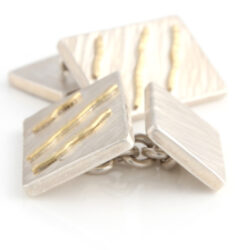 Silver cuff links with rays style with three gold wiggles