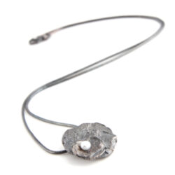 Pendant with three tiers of oxidised silver with white pearl