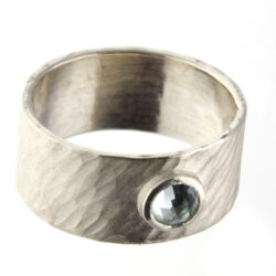 Green quartz set in gold on wide rays silver band