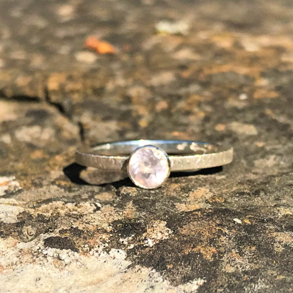 Stacking rose quartz in silver setting on slim silver band