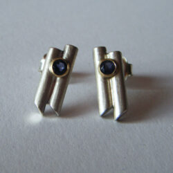 Gem is set in gold on 'bamboo' silver bar studs